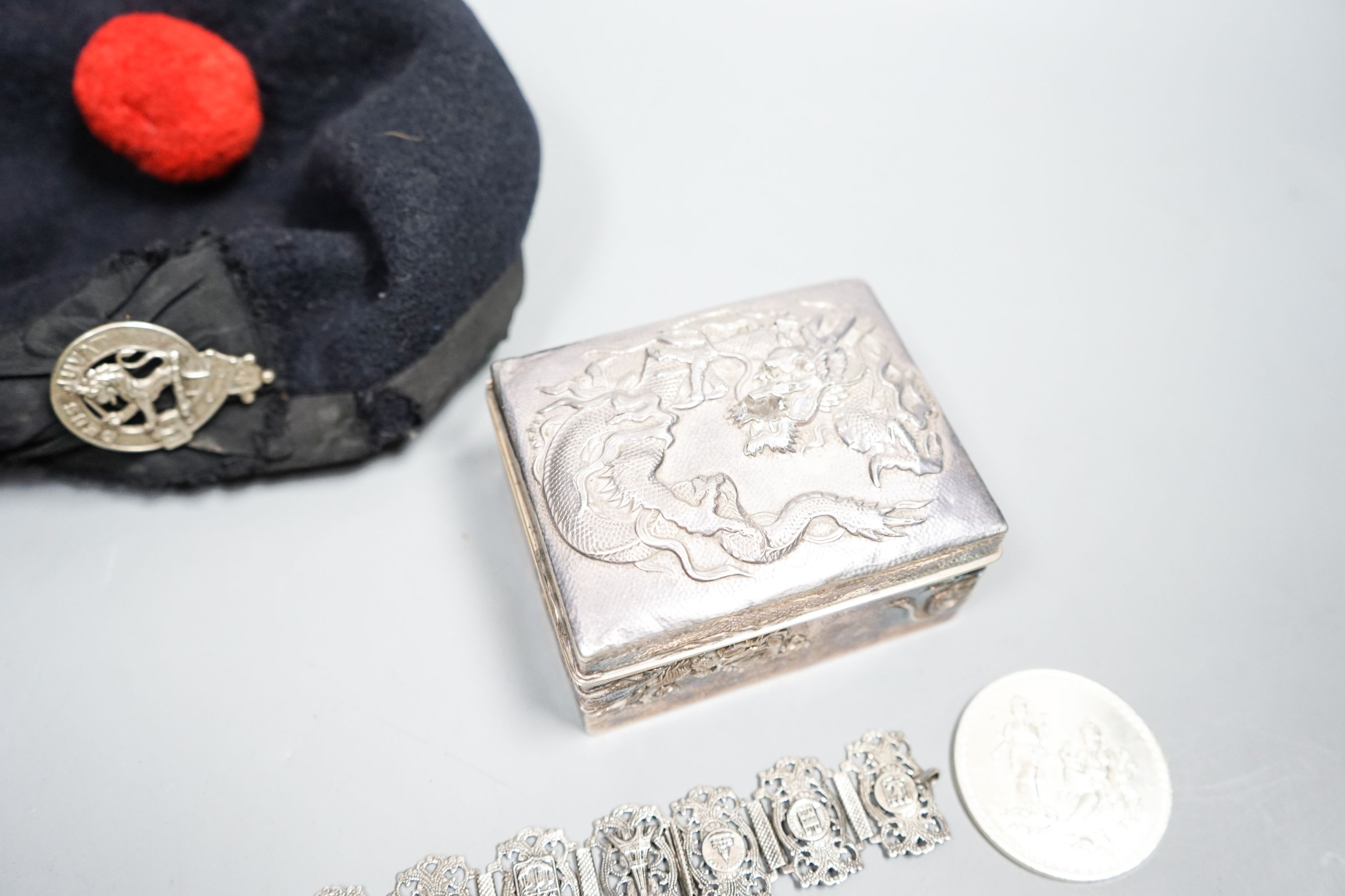 A Japanese silver box, bracelet, medal and military cap